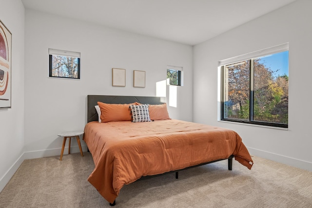 carpeted bedroom featuring baseboards