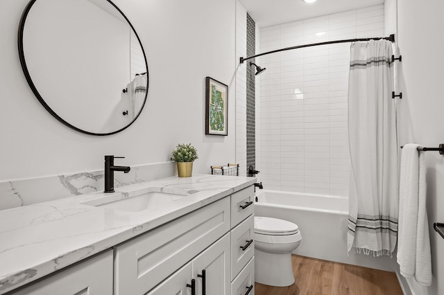 full bath with toilet, shower / tub combo with curtain, vanity, and wood finished floors