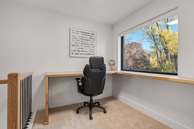 carpeted office space with baseboards and a healthy amount of sunlight