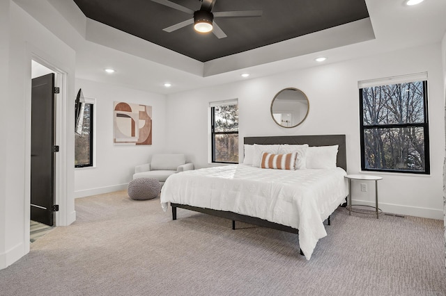 bedroom featuring baseboards, a raised ceiling, ceiling fan, carpet, and recessed lighting