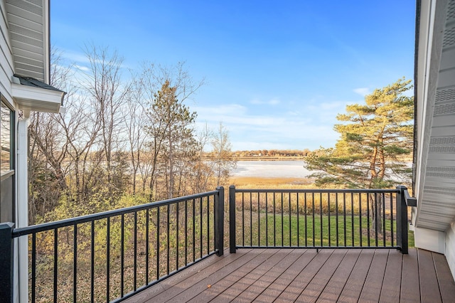 wooden terrace featuring a water view