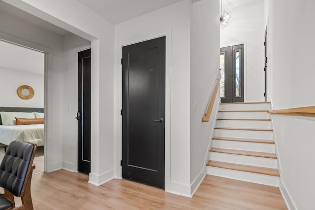 stairway with baseboards and wood finished floors