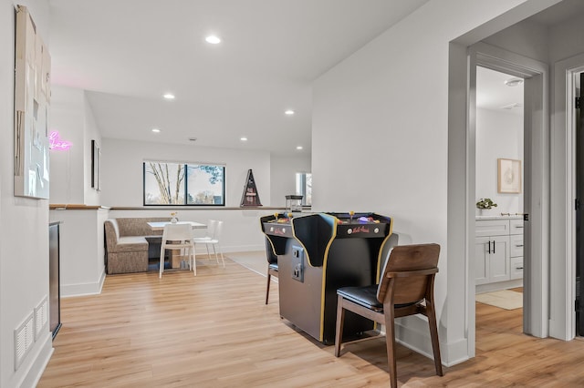 interior space featuring light wood-style floors, baseboards, and recessed lighting