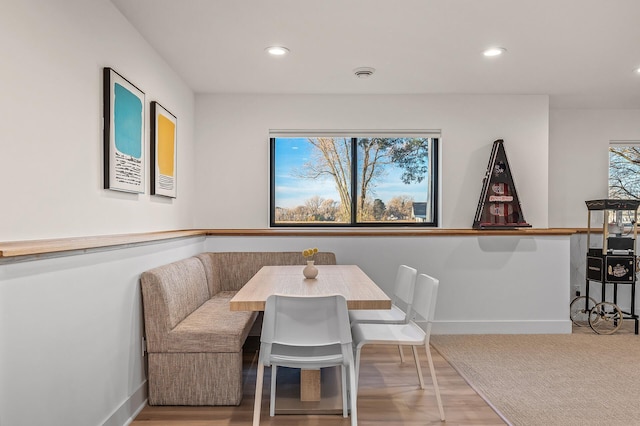 dining room with baseboards, recessed lighting, and wood finished floors