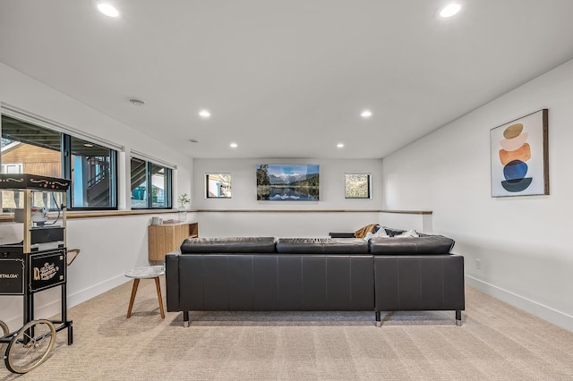 living area featuring baseboards, recessed lighting, and light carpet