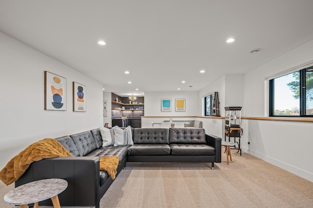 living area featuring light carpet, baseboards, and recessed lighting