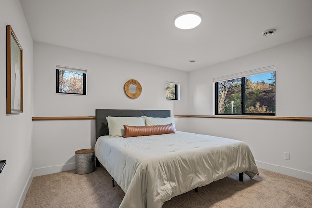 bedroom featuring visible vents, baseboards, and carpet