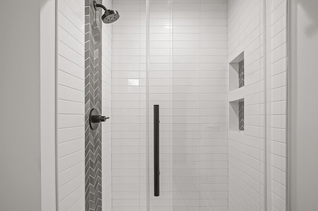 interior details featuring a stall shower