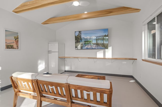interior space with baseboards and vaulted ceiling with beams