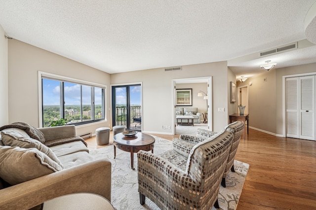 2950 Dean Pkwy Unit 2005, Minneapolis, MN 55416 - living area featuring a textured ceiling, wood finished floors, baseboard heating, and baseboards
