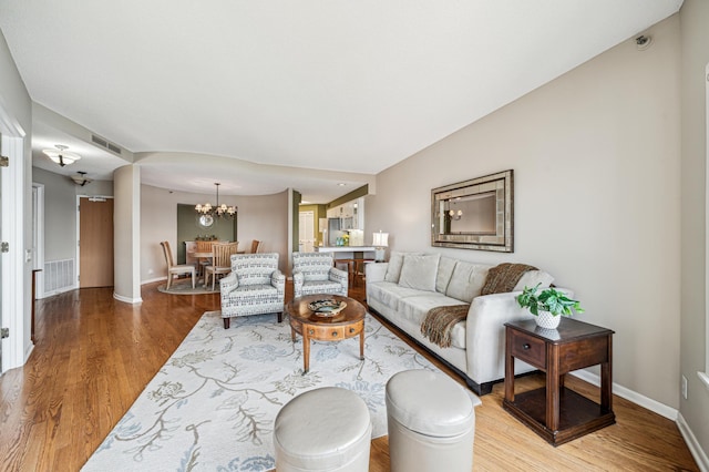 2950 Dean Pkwy Unit 2005, Minneapolis, MN 55416 - living area with wood finished floors, baseboards, and a chandelier