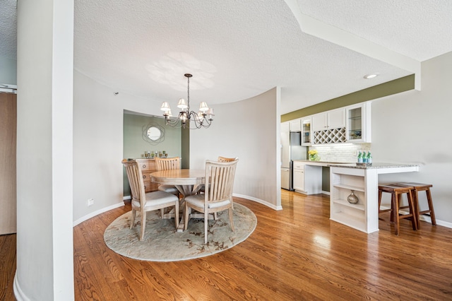 2950 Dean Pkwy Unit 2005, Minneapolis, MN 55416 - dining area with a textured ceiling, light wood-type flooring, baseboards, and a chandelier