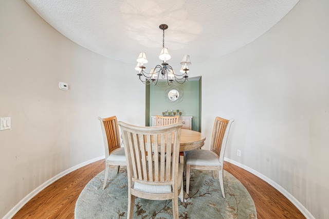 2950 Dean Pkwy Unit 2005, Minneapolis, MN 55416 - dining space with a chandelier, wood finished floors, baseboards, and a textured ceiling