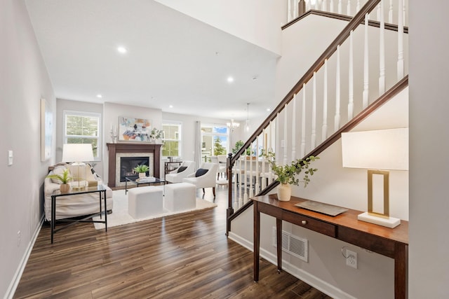 foyer entrance featuring visible vents, wood finished floors, baseboards, stairway, and recessed lighting
