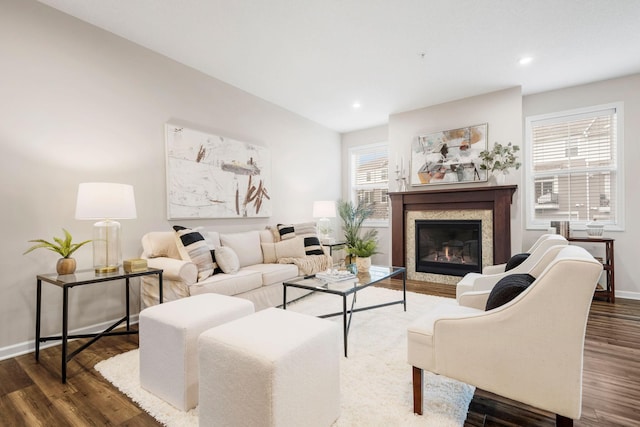 living room with baseboards, recessed lighting, wood finished floors, and a premium fireplace
