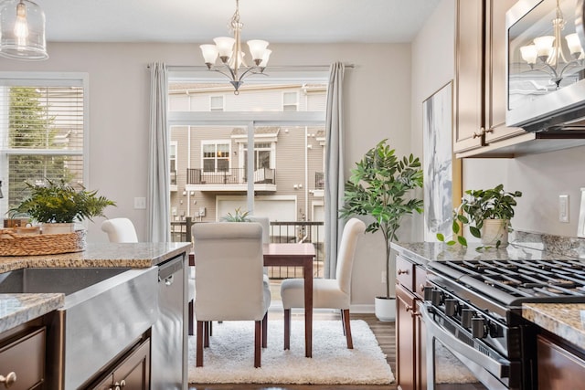 dining area featuring an inviting chandelier and wood finished floors