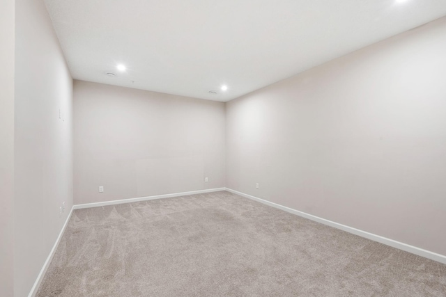 spare room with recessed lighting, carpet flooring, and baseboards