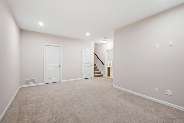 below grade area featuring visible vents, recessed lighting, stairs, and carpet floors