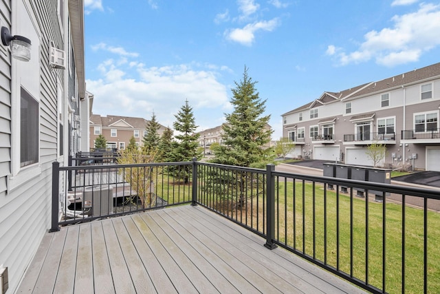deck featuring a residential view and a yard