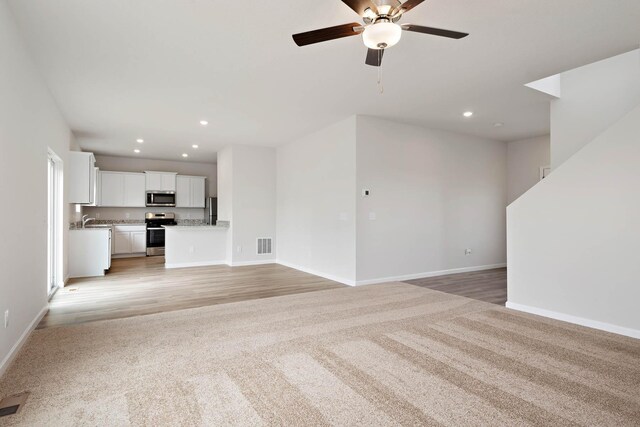 160 Summerfield Dr, Waverly, MN 55390 - unfurnished living room with ceiling fan, recessed lighting, light colored carpet, and light wood-type flooring