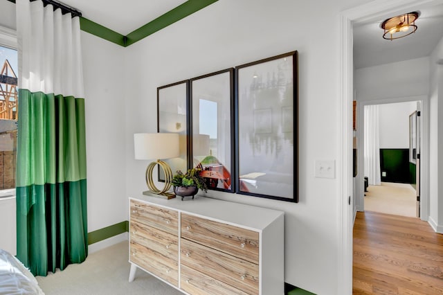 bedroom featuring baseboards and wood finished floors