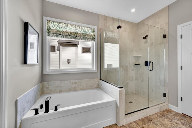 full bath with recessed lighting, a bath, and a stall shower