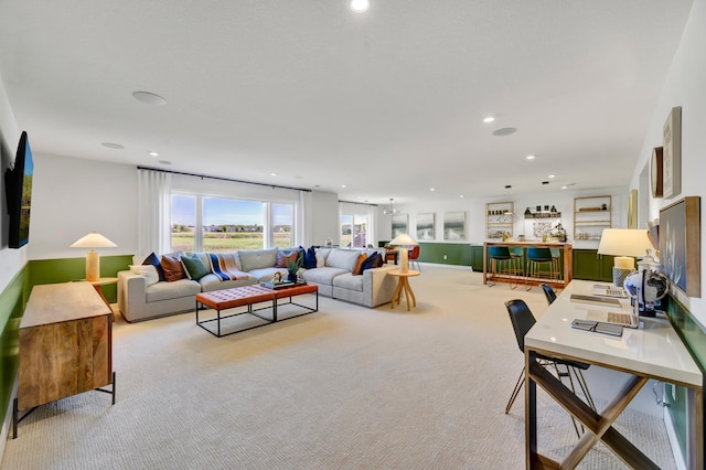 living area with light carpet and recessed lighting