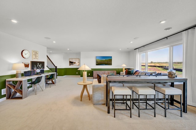 living area featuring stairway, baseboards, carpet floors, and recessed lighting