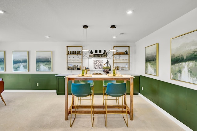 kitchen featuring open shelves, baseboards, green cabinetry, and recessed lighting