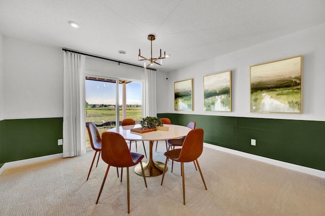 dining space with a chandelier, carpet, and baseboards