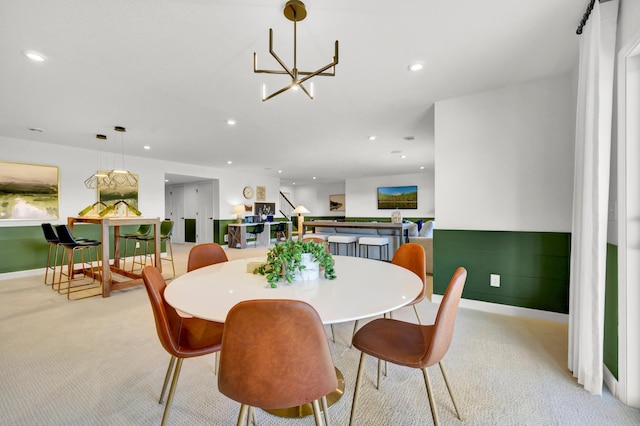 dining room with an inviting chandelier, baseboards, recessed lighting, and light colored carpet