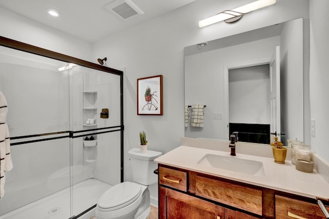 full bath featuring a shower stall, toilet, vanity, and visible vents