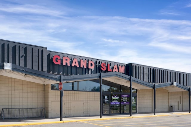 view of building exterior featuring uncovered parking