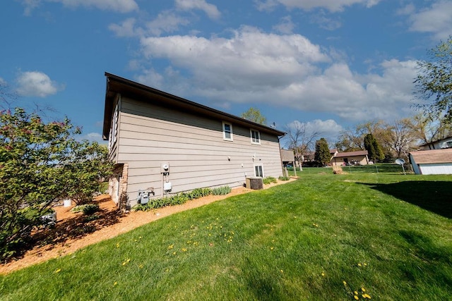 view of property exterior with cooling unit and a yard