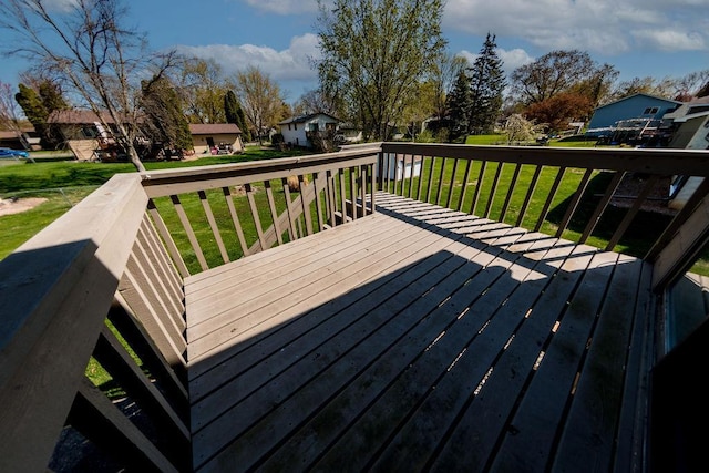 wooden terrace with a yard and a residential view