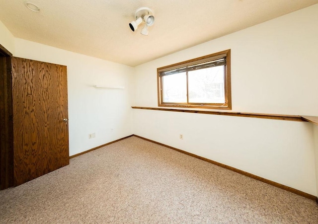 unfurnished bedroom with carpet floors and baseboards