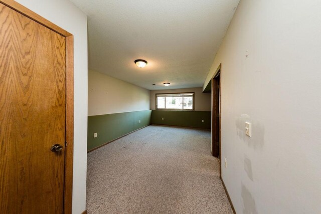 carpeted spare room with baseboards