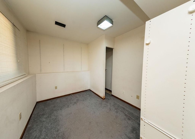 carpeted empty room with baseboards