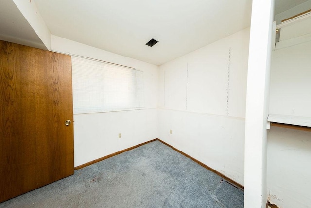 unfurnished room featuring carpet floors and baseboards