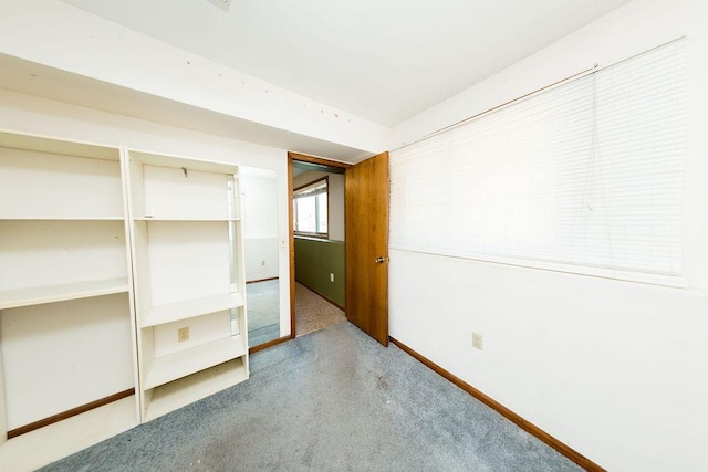 unfurnished bedroom featuring baseboards and a closet