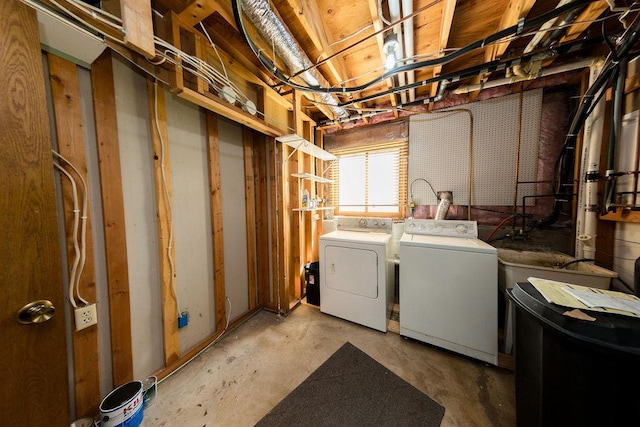 clothes washing area with washer and clothes dryer and laundry area