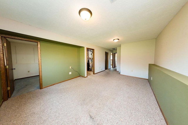 carpeted spare room with baseboards