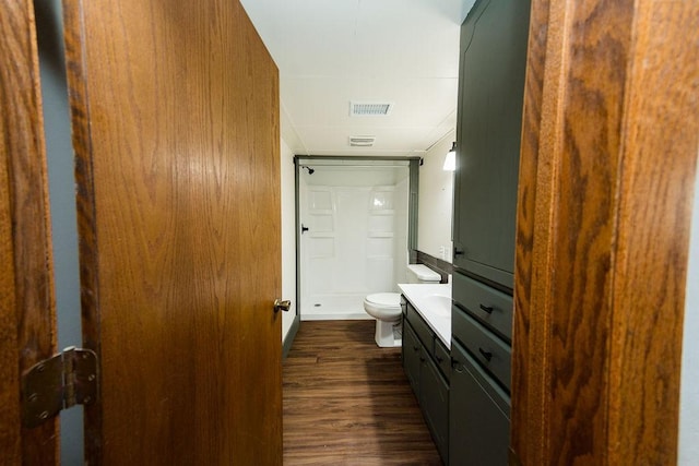 full bath featuring toilet, visible vents, a shower stall, vanity, and wood finished floors