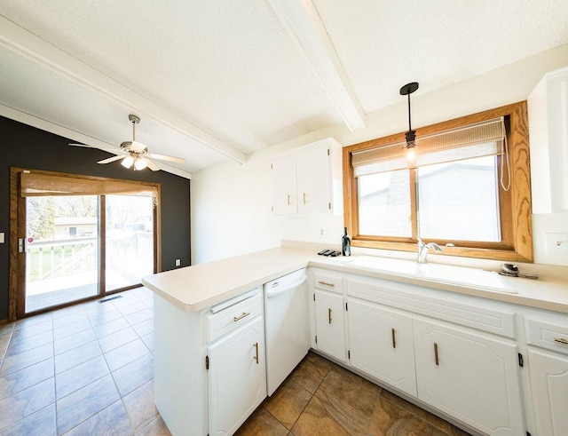 kitchen featuring a sink, a peninsula, dishwasher, ceiling fan, and white cabinetry