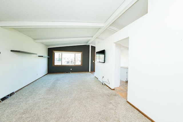 empty room featuring carpet flooring, baseboards, and lofted ceiling with beams