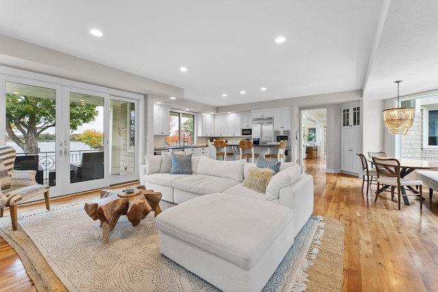2625 Woodbridge Rd, Minnetonka Beach, MN 55391 - living area featuring light wood-type flooring, french doors, recessed lighting, and a chandelier