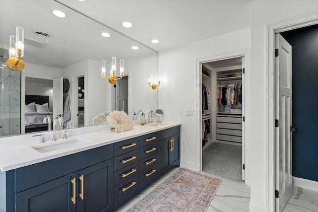 2625 Woodbridge Rd, Minnetonka Beach, MN 55391 - ensuite bathroom with double vanity, marble finish floors, recessed lighting, a spacious closet, and a chandelier