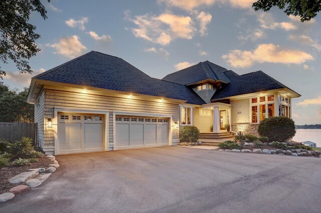 2625 Woodbridge Rd, Minnetonka Beach, MN 55391 - view of front facade with driveway, a garage, and a shingled roof