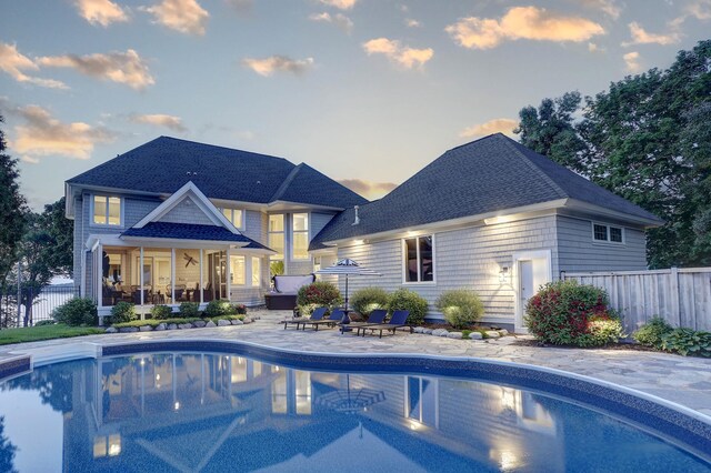 2625 Woodbridge Rd, Minnetonka Beach, MN 55391 - back of property at dusk featuring a patio area and roof with shingles