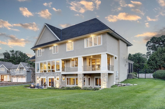 2625 Woodbridge Rd, Minnetonka Beach, MN 55391 - back of property at dusk with stone siding and a balcony